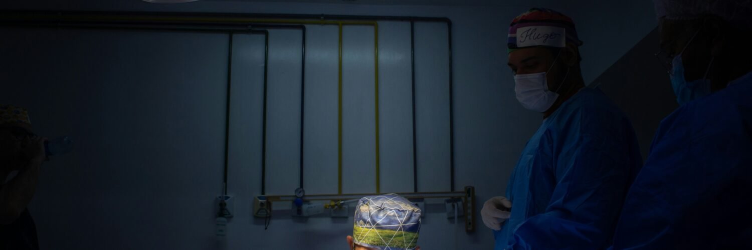 a group of doctors in scrubs in a dark room